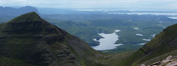 A view of hills with a body of water in the middle