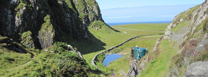 A view of a tank between to hill and a view of the sea
