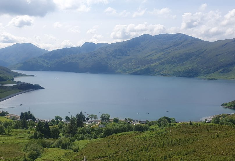 A body of water with hills in the background