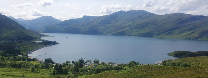A body of water with hills in the background